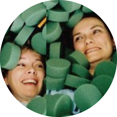 two people playing with green foam discs